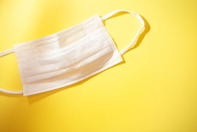 High angle view of hat on yellow background