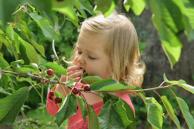 Close-up of young woman amidst plants