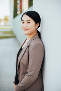 Portrait of smiling businesswoman standing in office