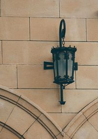 Low angle view of street light against wall