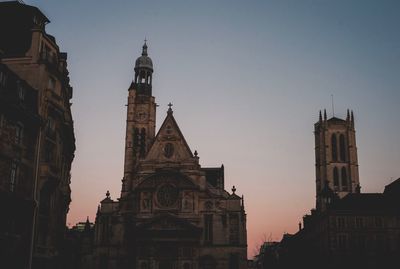 Low angle view of buildings against sky during sunset