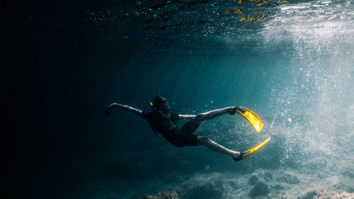 Full length of woman swimming undersea