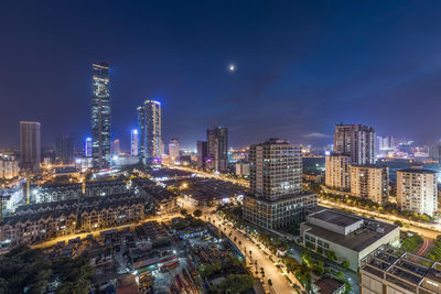 High angle view of city lit up at night