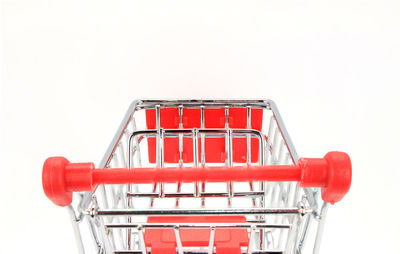 Close-up of shopping cart against white background