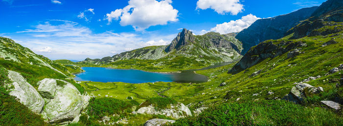 Scenic view of lake amidst mountains against sky