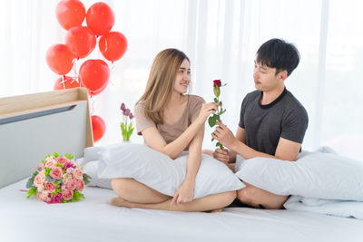 Young couple sitting on wall