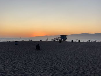 Scenic view of beach against sky during sunset