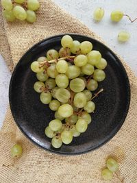 High angle view of grapes in bowl on table