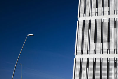 Low angle view of skyscraper against blue sky