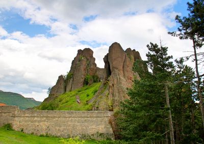 Low angle view of rock formations against sky