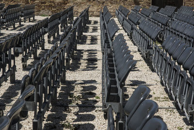 High angle view of chairs on cobblestone street