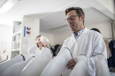 Cheese factory workers putting on protective clothes