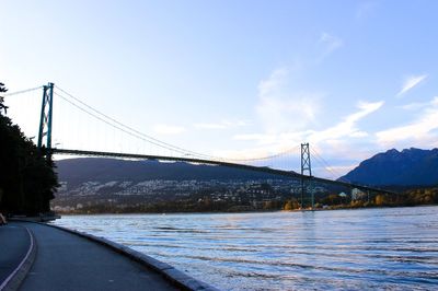 Suspension bridge over water against sky