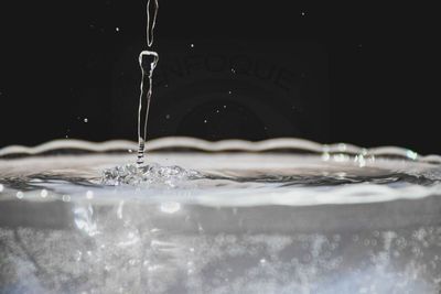 Close-up of water splashing in glass