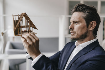 Architect examining architectural model