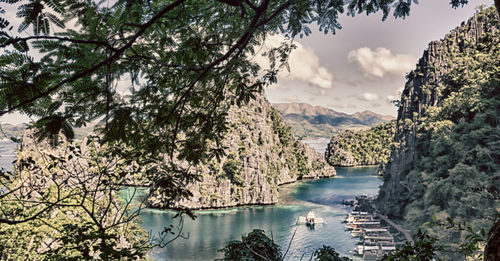 Scenic view of sea and mountains against sky