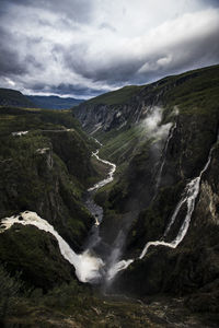 Scenic view of waterfall against sky