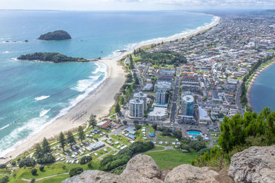 High angle view of sea and buildings in city