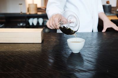 Midsection of man preparing food on table