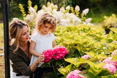 Mother and daughter on flowering plants