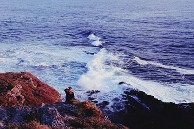 High angle view of woman on rocky shore