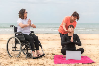 Friends sitting on beach