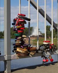 Close-up of padlocks hanging on metal against sky