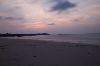 Scenic view of beach against sky during sunset