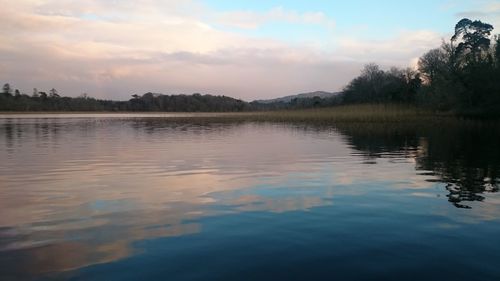 Scenic view of lake against sky at sunset