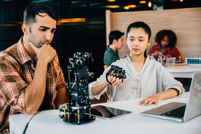 Young woman using laptop at table