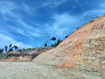 Low angle view of rocks on mountain against sky