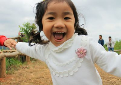 Portrait of cute girl standing outdoors