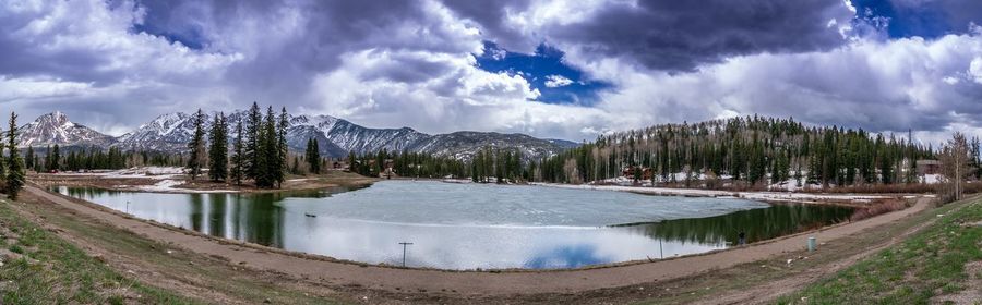 Panoramic view of lake and trees against sky