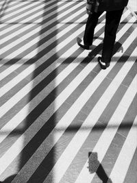 Low section of woman walking on floor