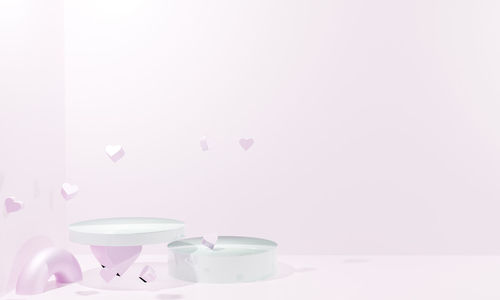 Close-up of white flowers on table against wall at home