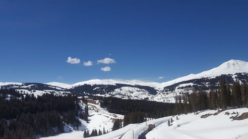 Scenic view of snowcapped mountains against clear blue sky