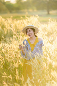 Portrait of smiling woman standing on field