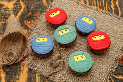 High angle view of colorful cookies on wooden table during christmas