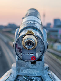 Close-up of coin-operated binoculars against sky