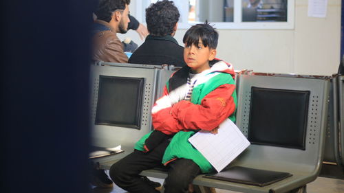 Boy sitting on chair at hospital