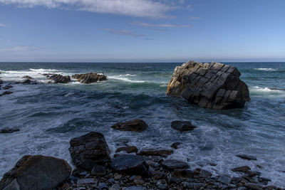 Rocks in sea against sky