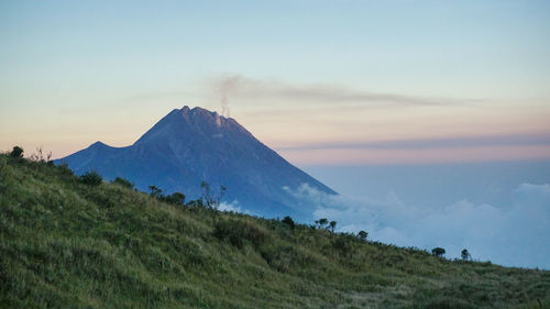 Scenic view of landscape against sky during sunrise