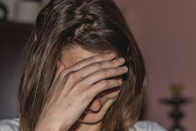 Close-up portrait of beautiful woman at home