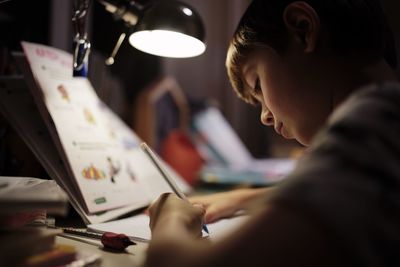 Side view of young woman working at office