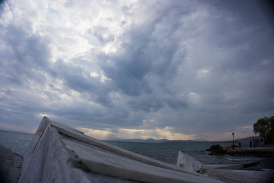 Scenic view of snow covered landscape against storm clouds