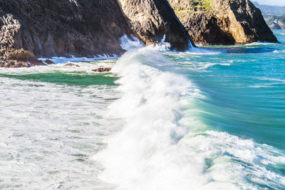 View of waves breaking on rocks