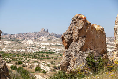 Rock formations on landscape against clear sky