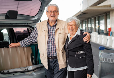 Portrait of female friends standing in car