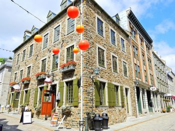 Low angle view of street light against building in quebec, canada