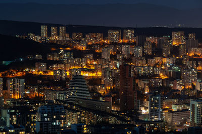 High angle view of illuminated city buildings at night